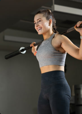 Member smiling during a strength session