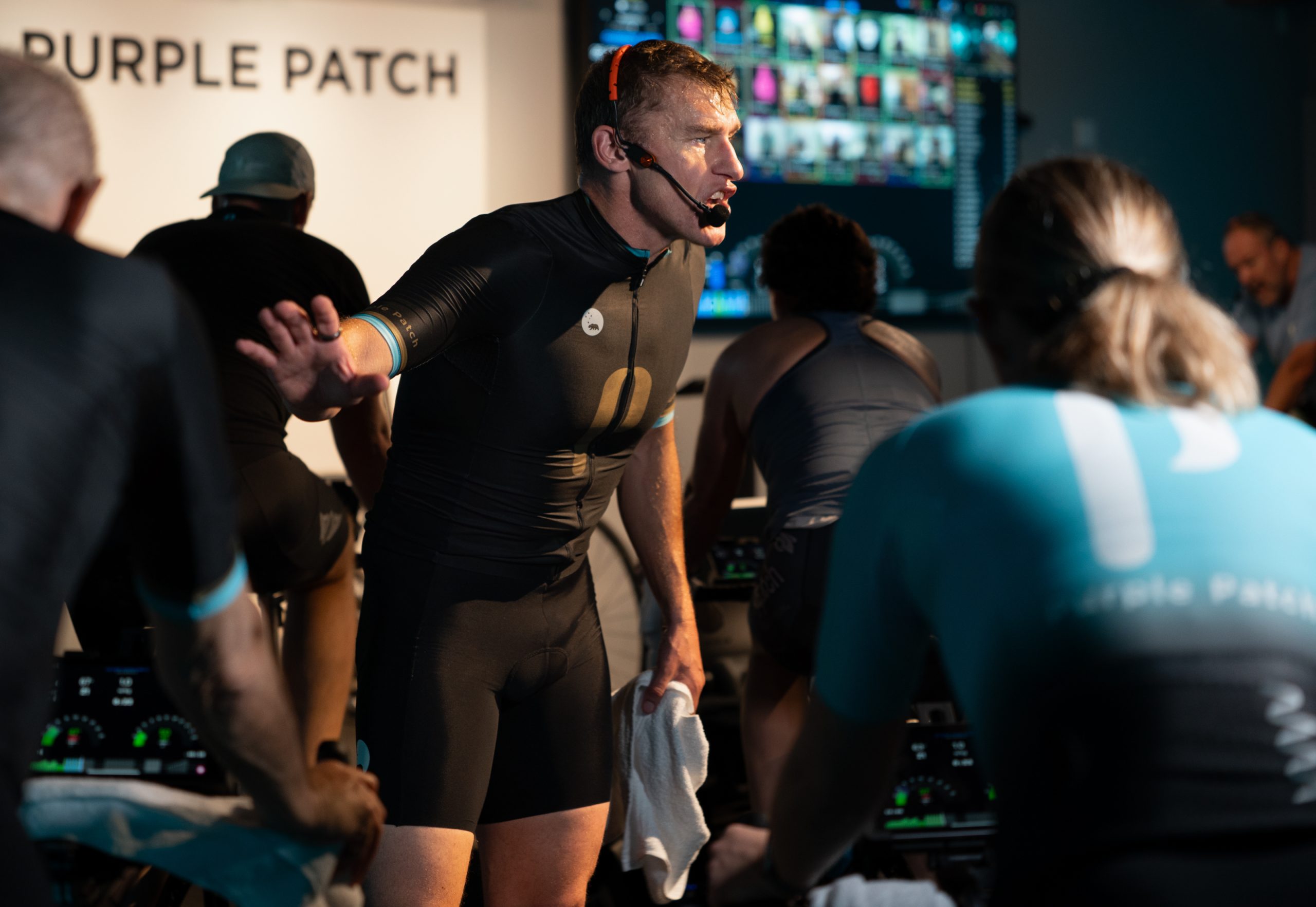 Coach giving cues during a bike class