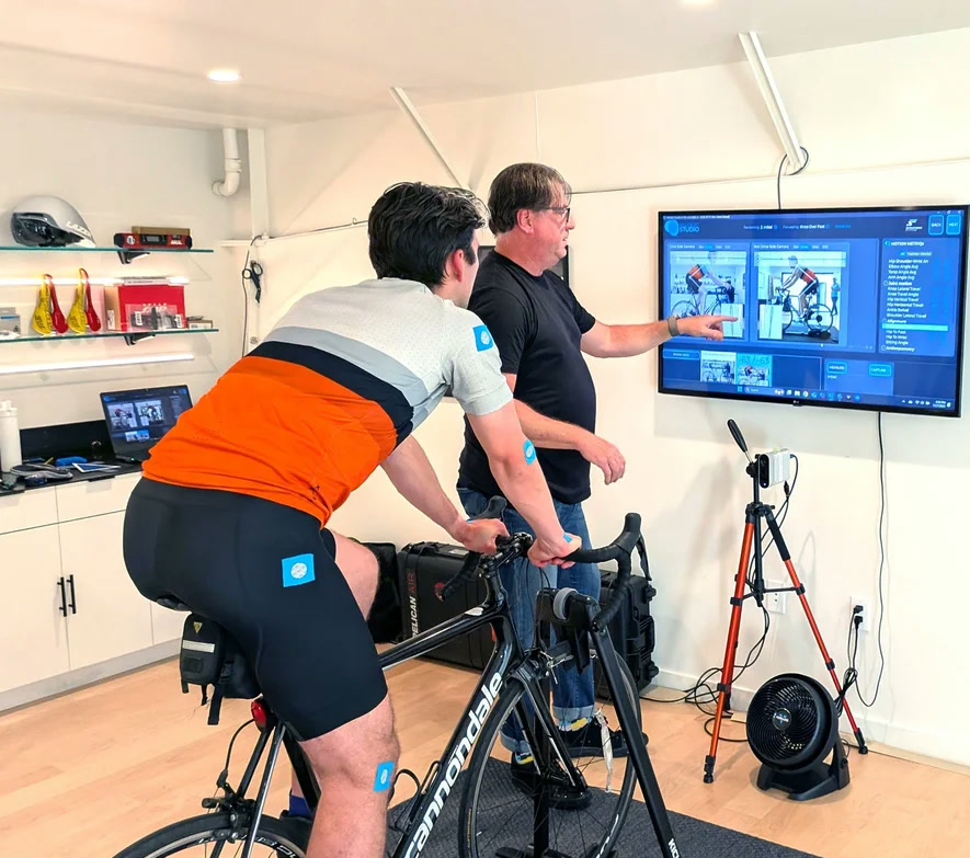 Chris Soden reviewing motion-capture data with a rider on the bike