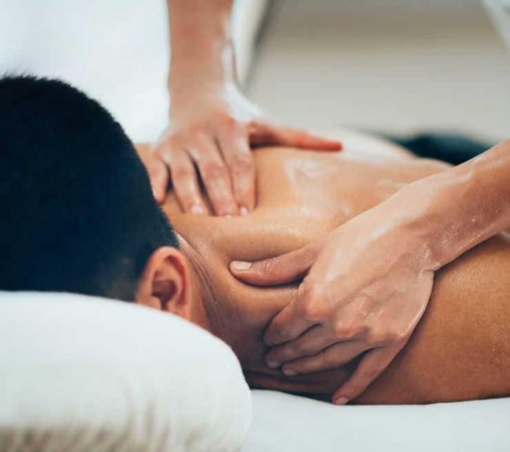 Therapist massaging an athlete’s upper back