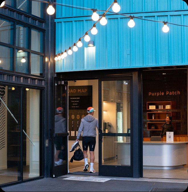 A member arriving at the Center under the string lights
