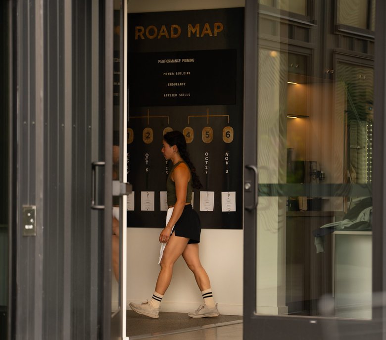 A member walking past the Road Map wall