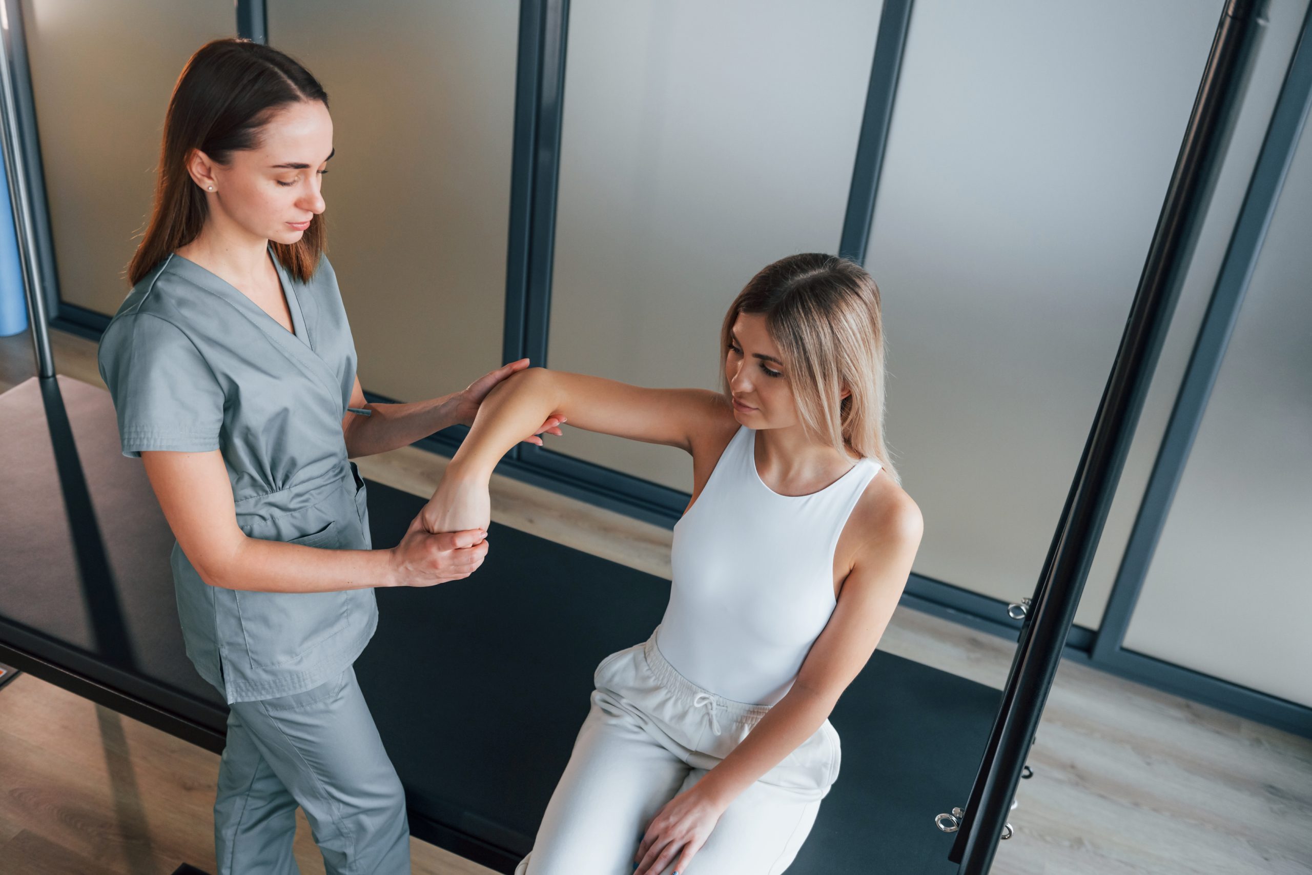 Physical therapist guiding a patient through movement